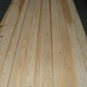Several light-colored pine boards laid side by side showing straight grain patterns and smooth planed surfaces.